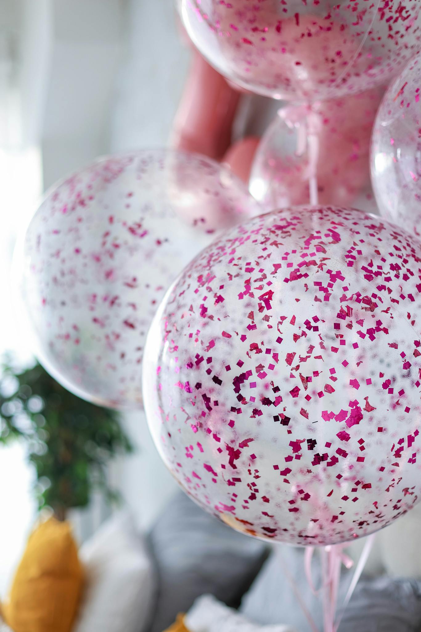 Bright and festive pink confetti balloons photographed indoors, ideal for celebration themes.